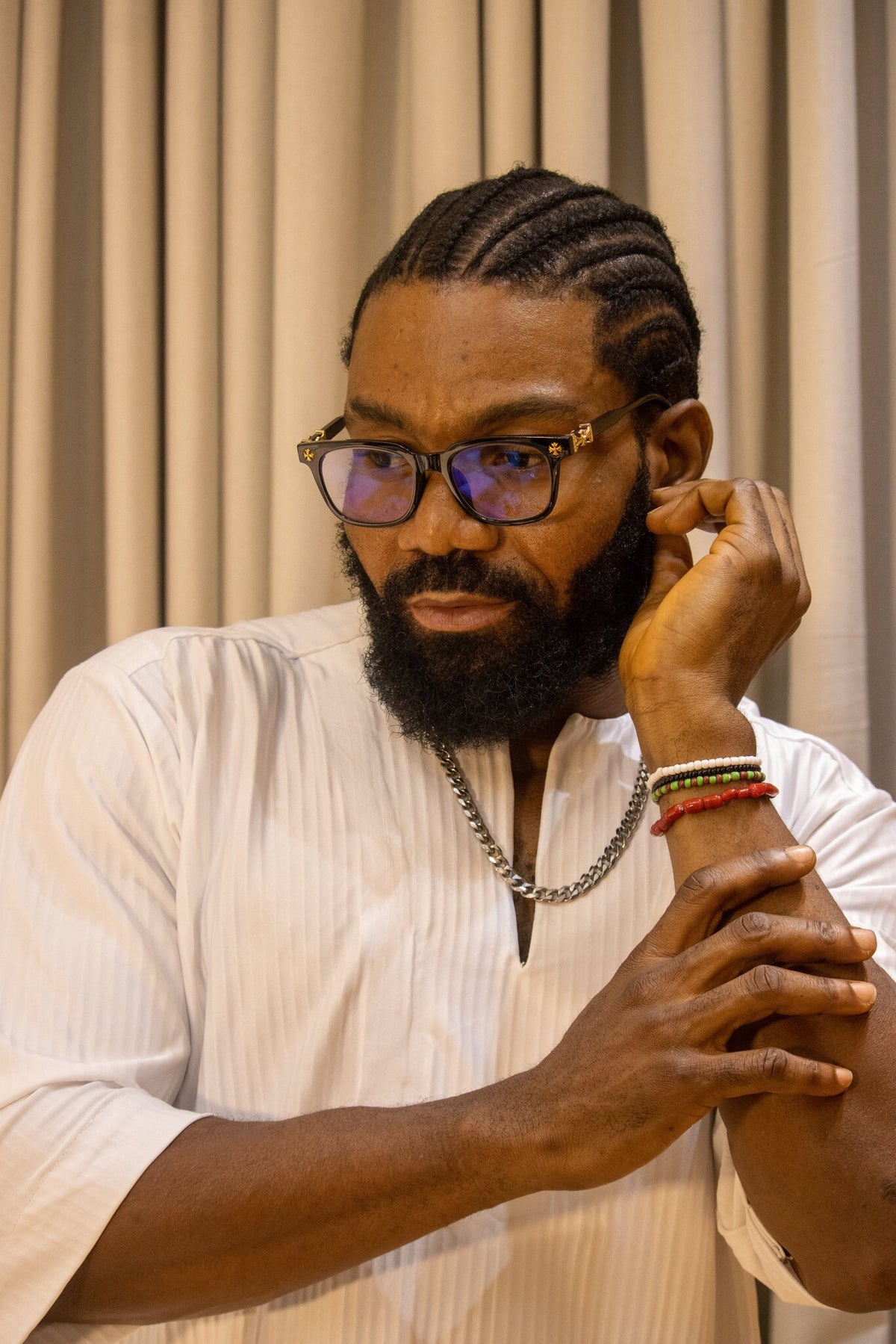 Model wearing the Odùduwà Ancestral Bracelet, hand-strung coral beads