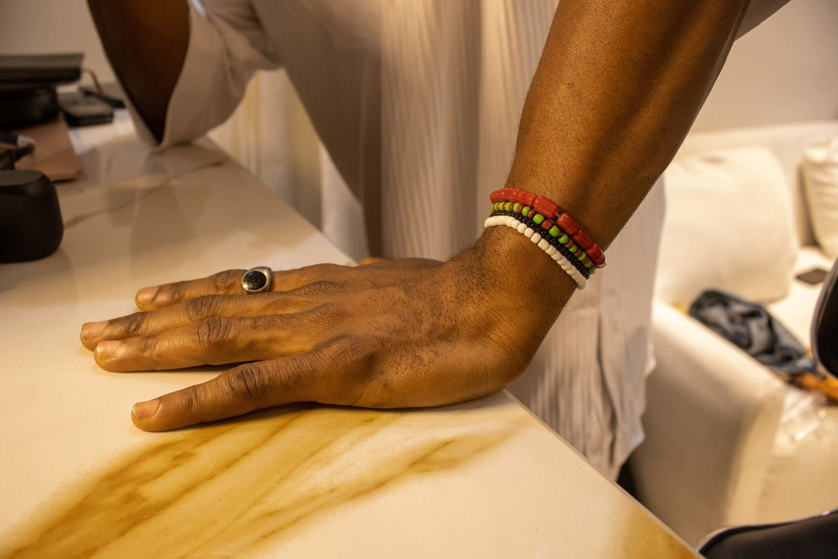 Model wearing the Odùduwà Ancestral Bracelet, hand-strung coral beads