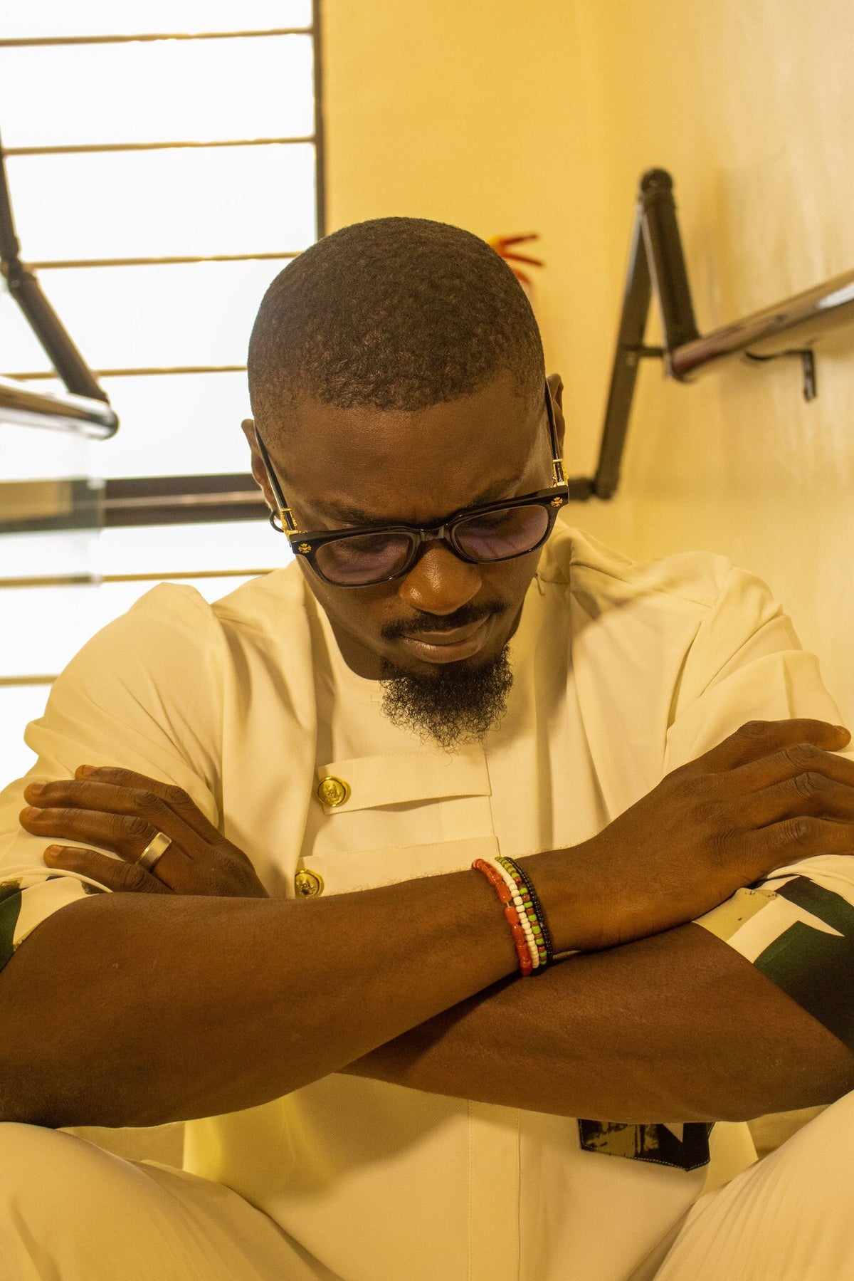 Model wearing the Odùduwà Ancestral Bracelet, hand-strung coral beads